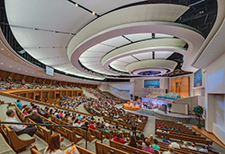 First Baptist Church Pasadena (Pasadena, TX) is quite large, with a 2,800-seat sanctuary. The design challenge here was to accommodate the large congregation while maintaining a sense of intimacy. This was done through the use of tiered and gather-round seating. Photo shown is taken from the furthest point of the sanctuary.