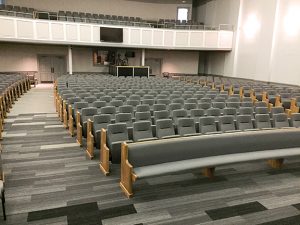 Sauder Worship Seating installation at Apex Baptist Church (Apex, NC) — a combination of radial and mitered pews, along with Clarity auditorium seating 
