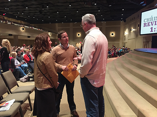 Pastor Lance Taylor convenes with church members after a recent worship service.
