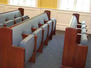 Combination upholstered pew back with flip-up auditorium seat